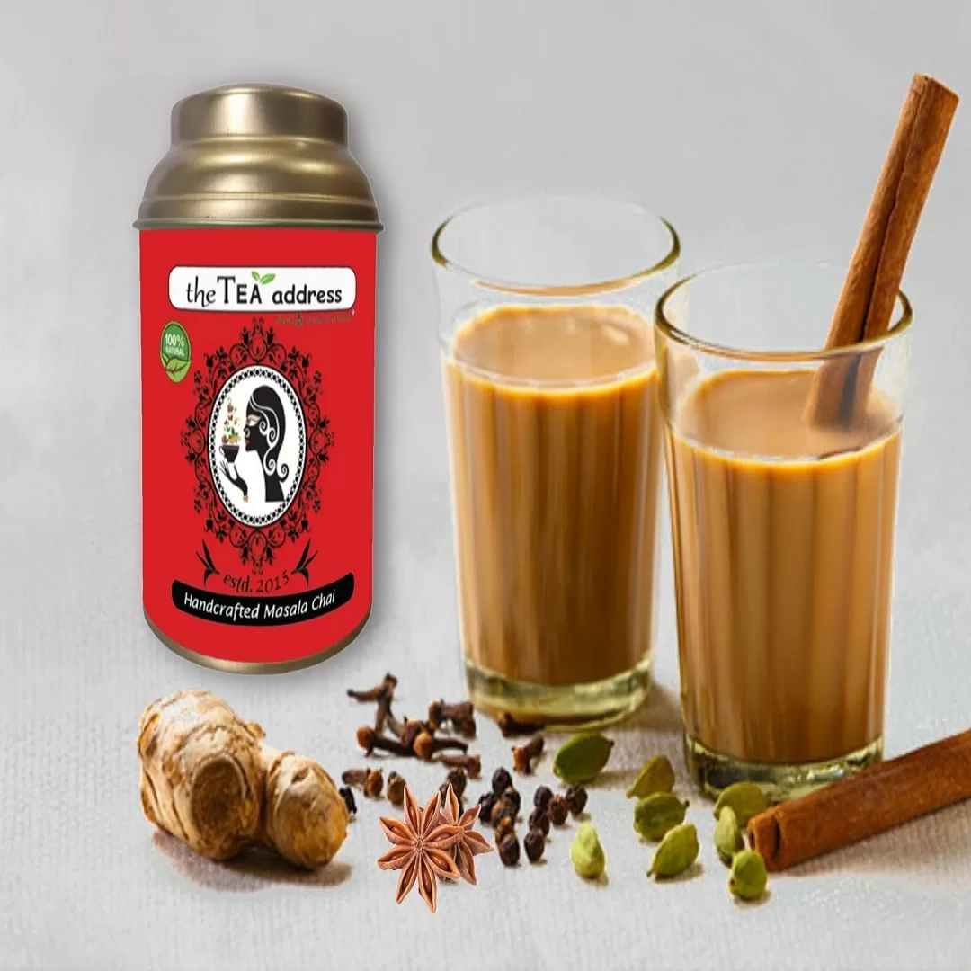 Image of handcrafted masala chai packed in golden tin caddy and arranged