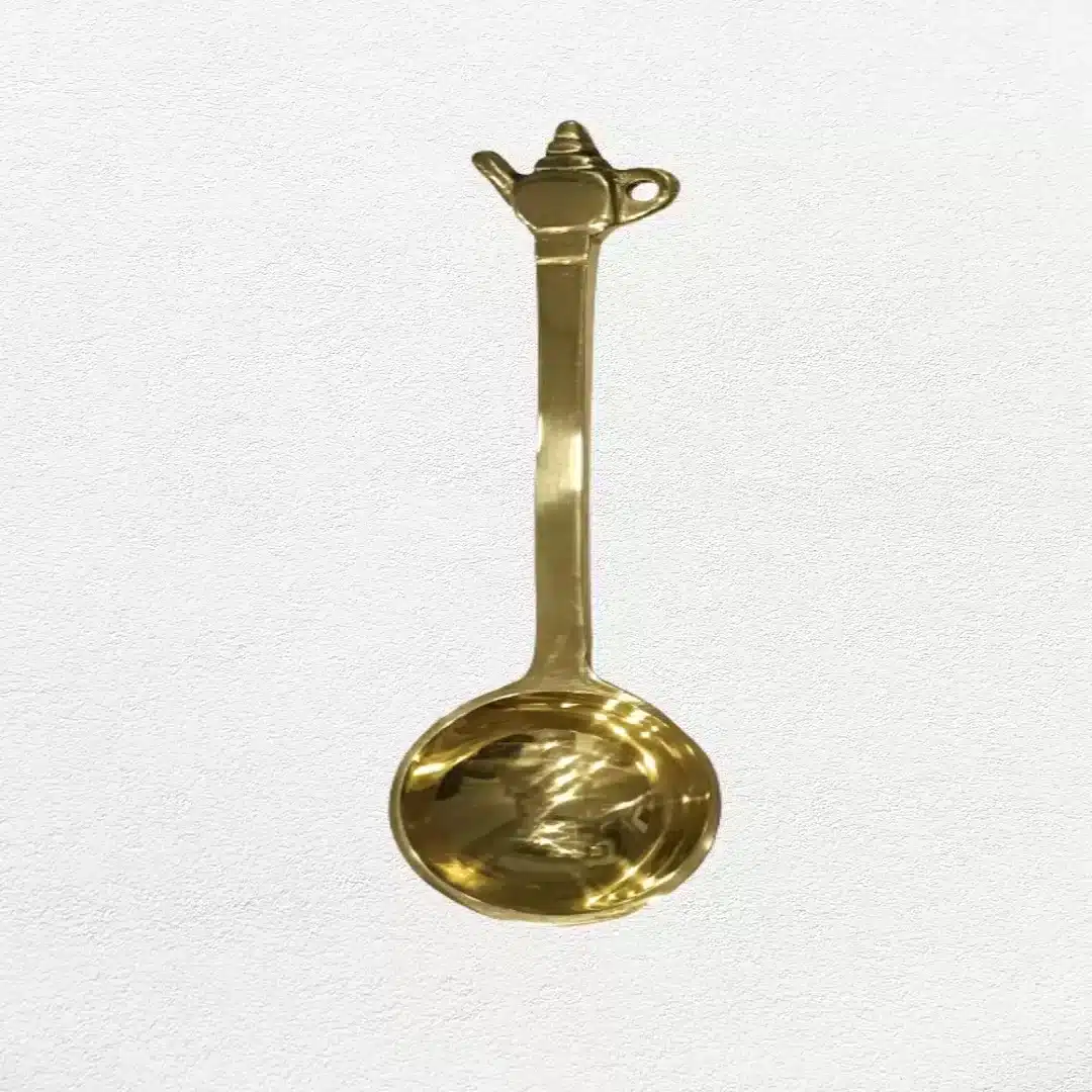 image of decorative brass teaspoon with kettle shape end